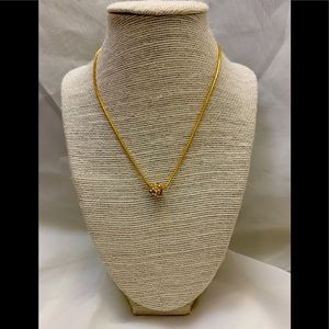 Gold necklace with spinner charm cover in bling.